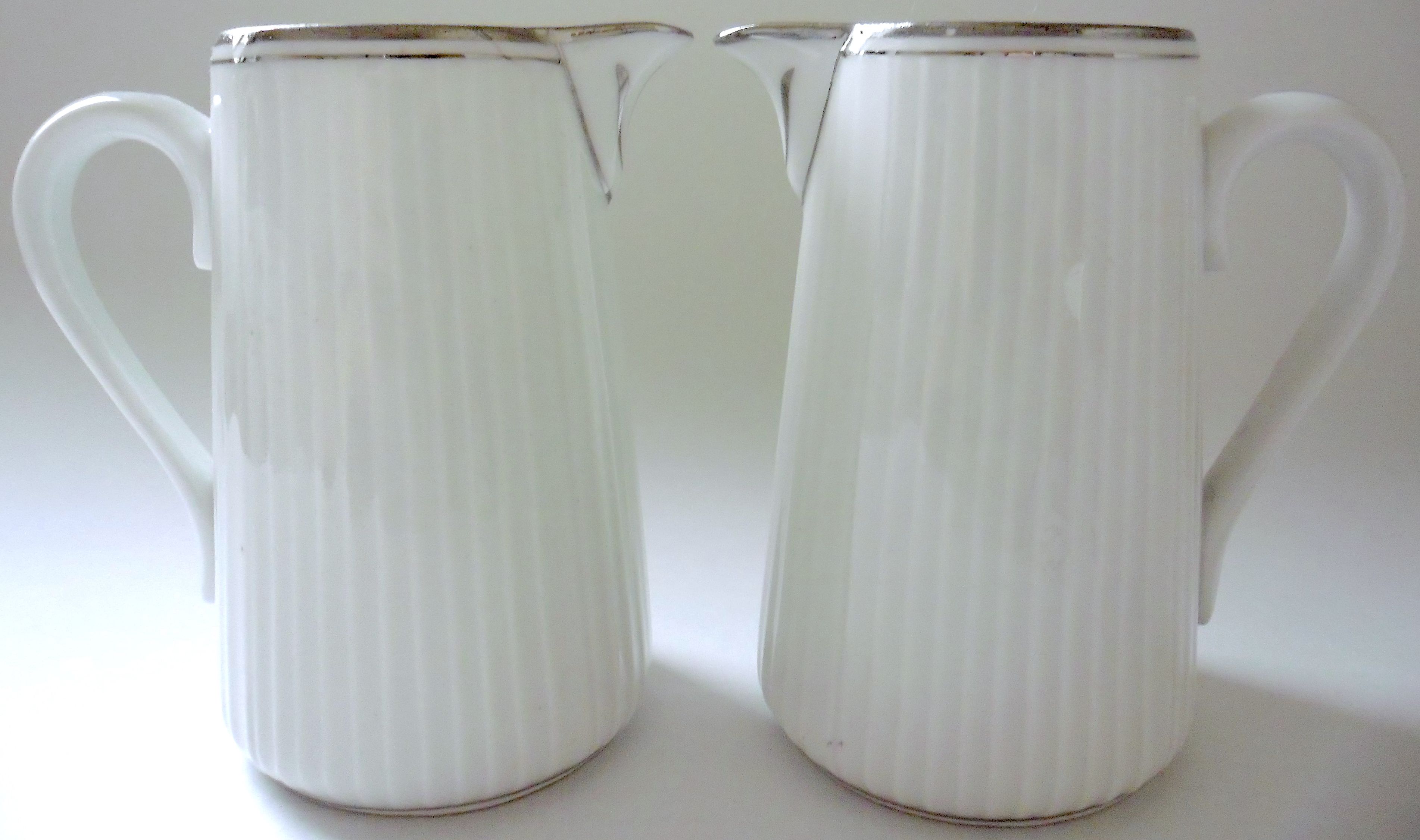 Pair of creamers in white porcelain enhanced with platinum