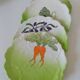 4 hand-decorated earthenware plates with vegetable and green leaf designs.