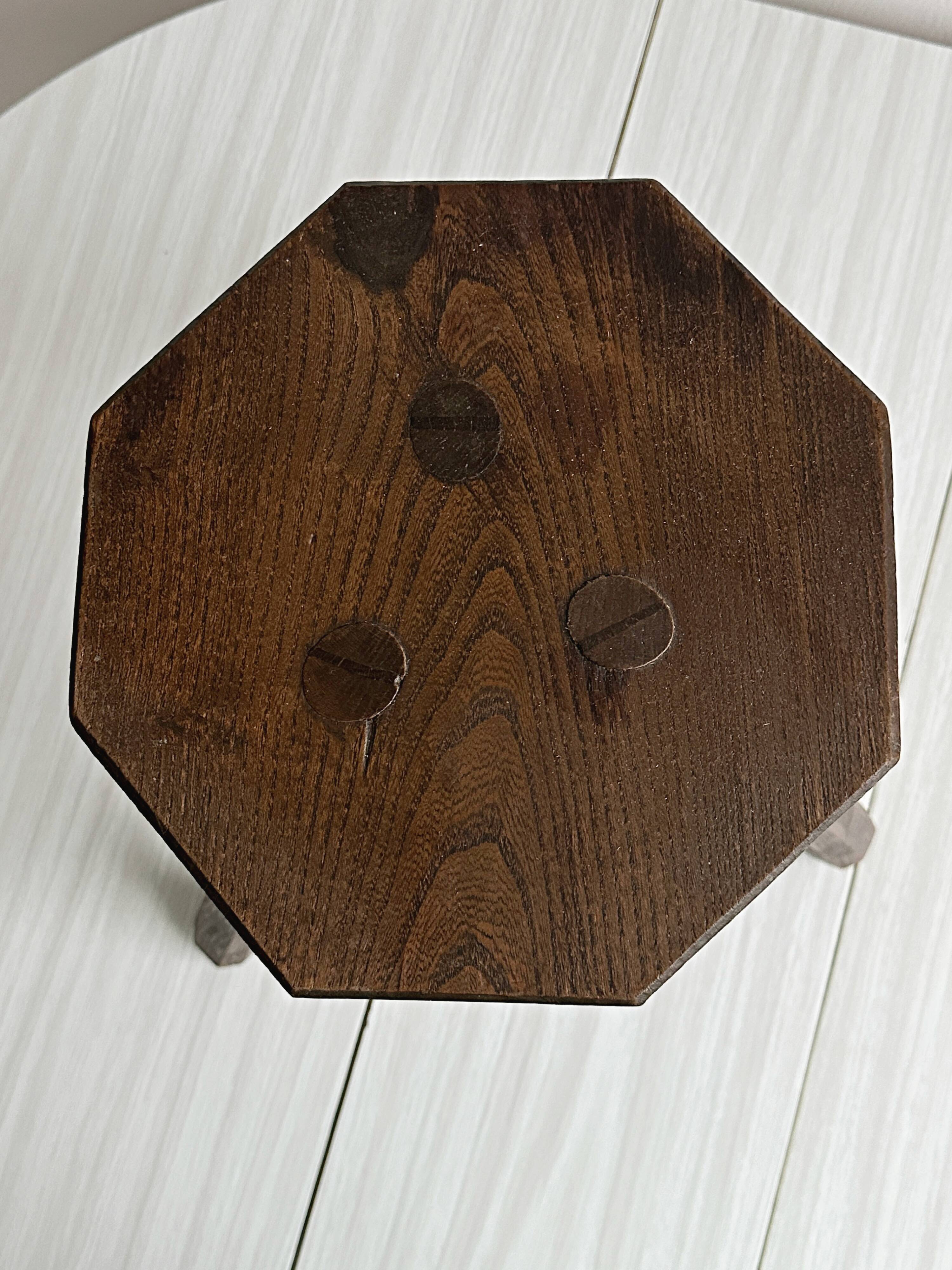Small dark wooden tripod stool