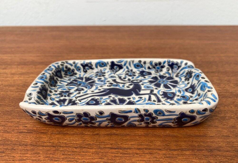 Vintage handmade blue ceramic ashtray with deer and flower ornament from Rodos Ceramics.