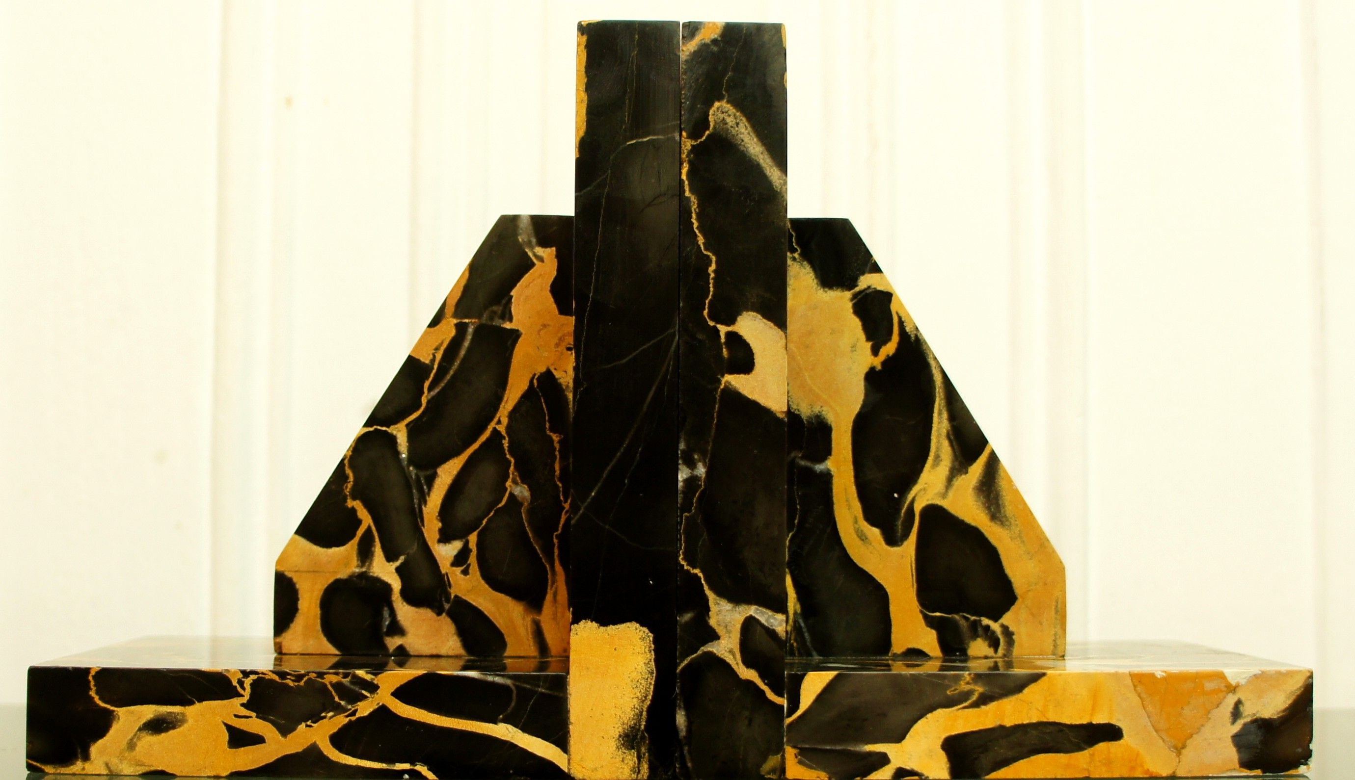 Pair of Portor marble bookends, black and golden yellow