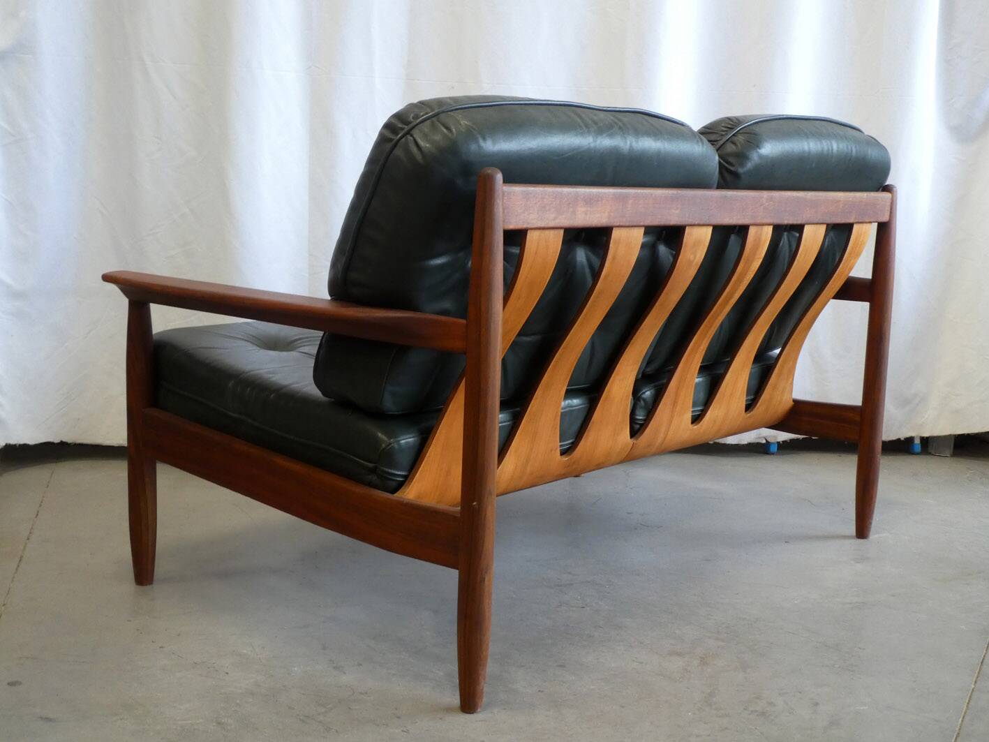 Scandinavian sofa in teak and green leather