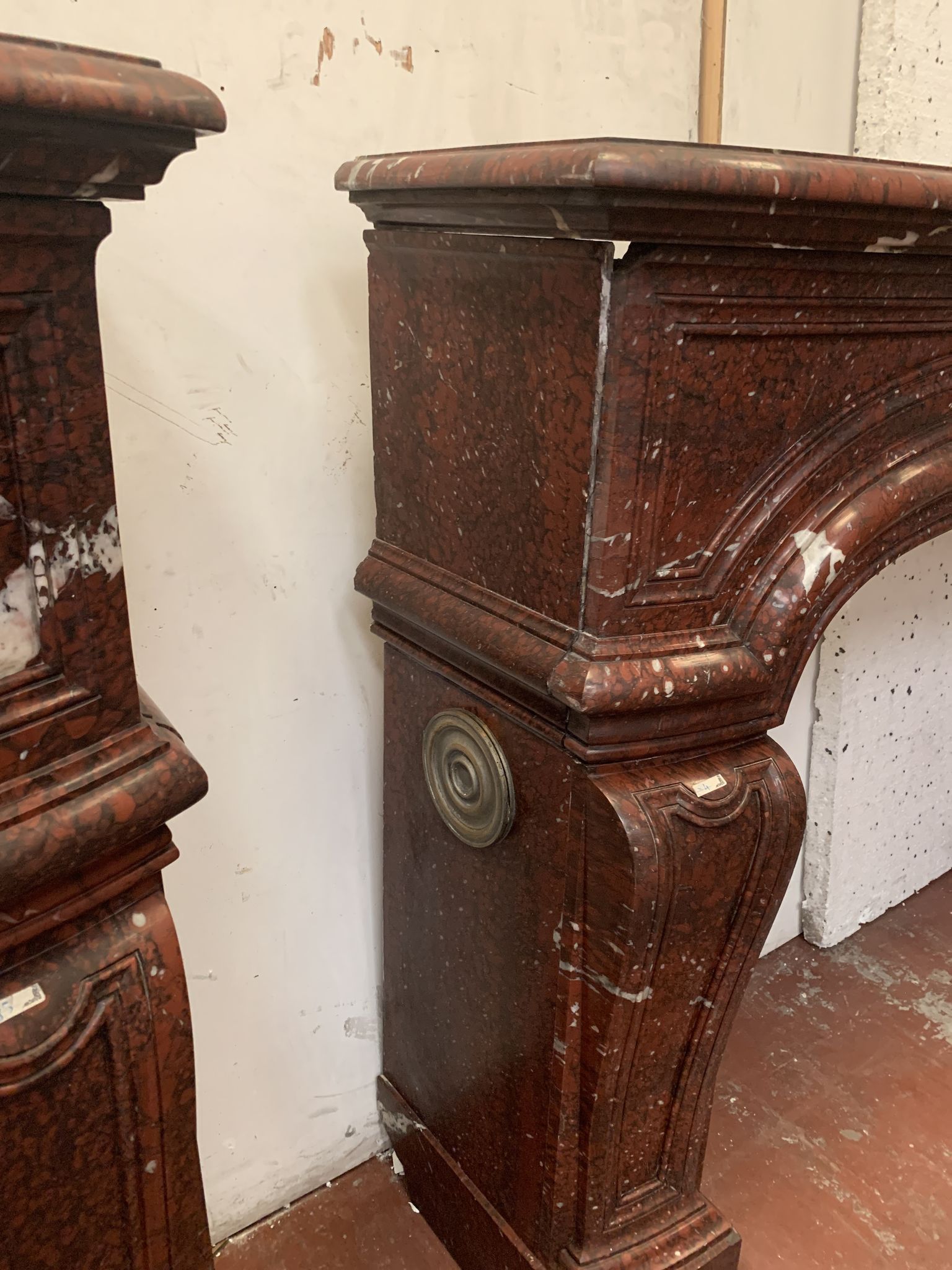 Pair of Louis XIV style fireplaces in red cherry marble. XIX century.