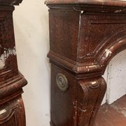 Pair of Louis XIV style fireplaces in red cherry marble. XIX century.
