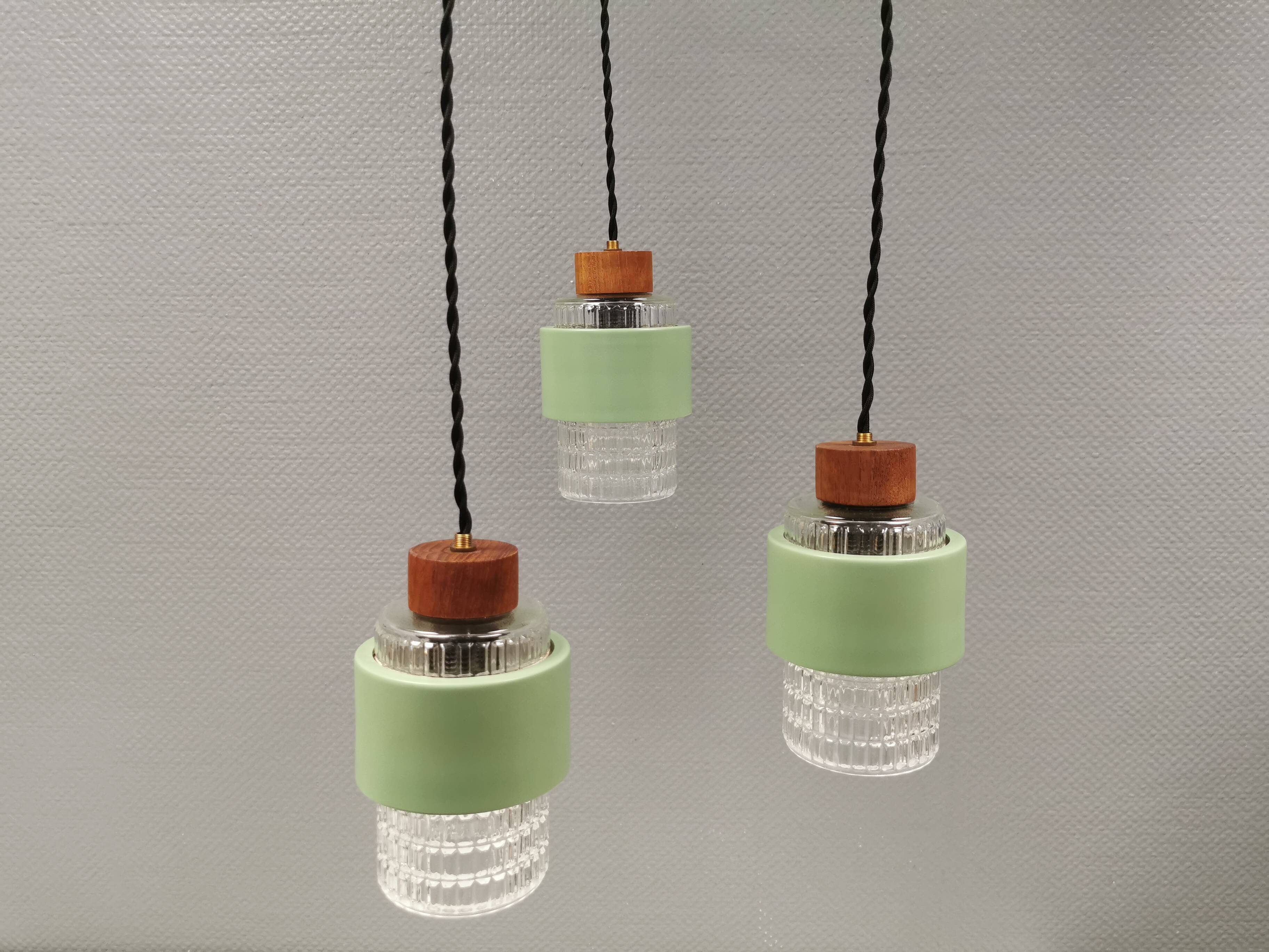 Three-part pendant in crystal glass, teak wood, and thin dusty green metal