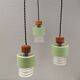 Three-part pendant in crystal glass, teak wood, and thin dusty green metal