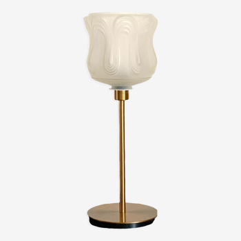 Art Deco style lamp with an antique white glass lampshade mounted on a golden foot