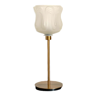 Art Deco style lamp with an antique white glass lampshade mounted on a golden foot