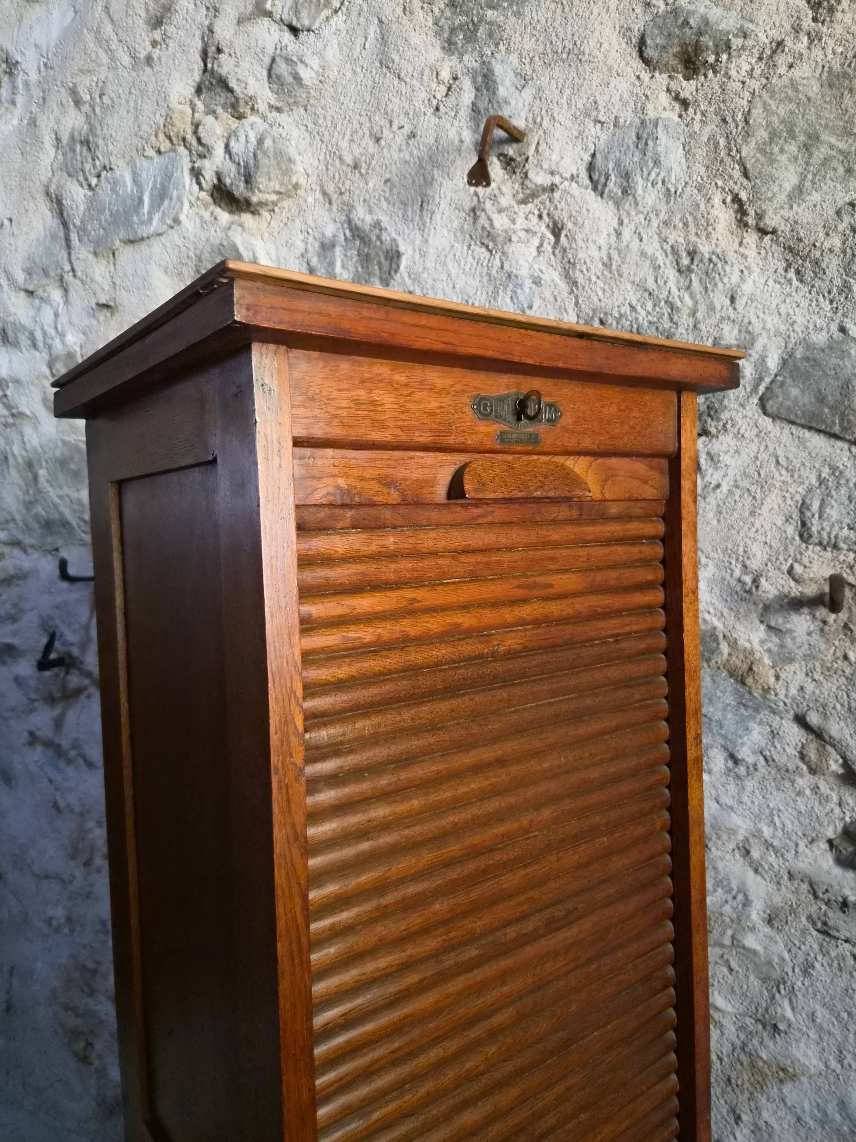 French antique wardrobe with curtain in oak, circa 1920–1930.