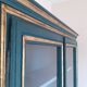 Glass-fronted cabinet in weathered green wood