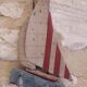 Wooden and metal hook in the shape of a sailboat