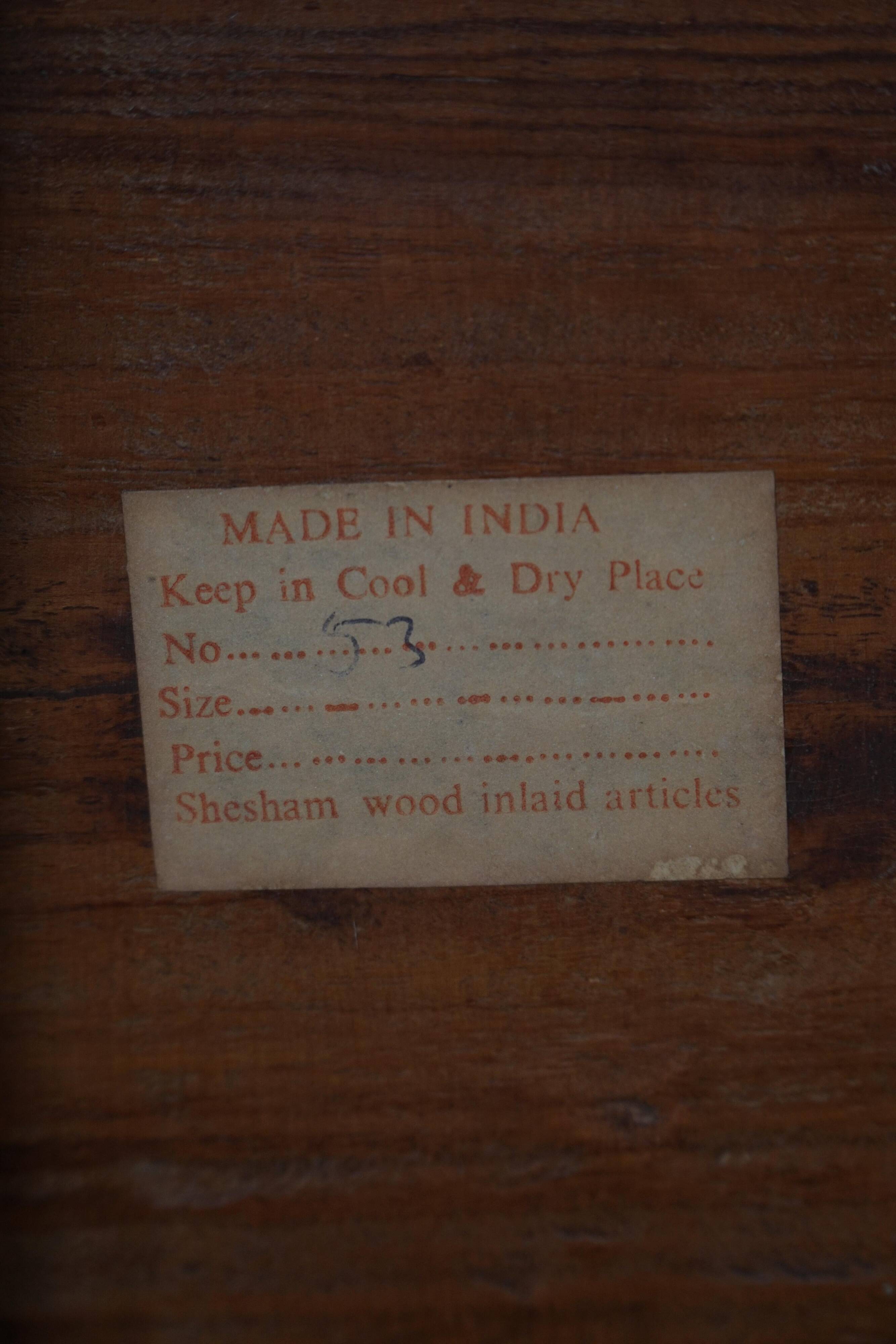 Vintage Indian teak coffee table inlaid with elephant motifs, mid-20th century.