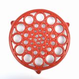 Vintage red enameled cast iron trivet
