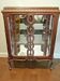 A Louis XV style display cabinet with three beechwood shelves and a white marble top.