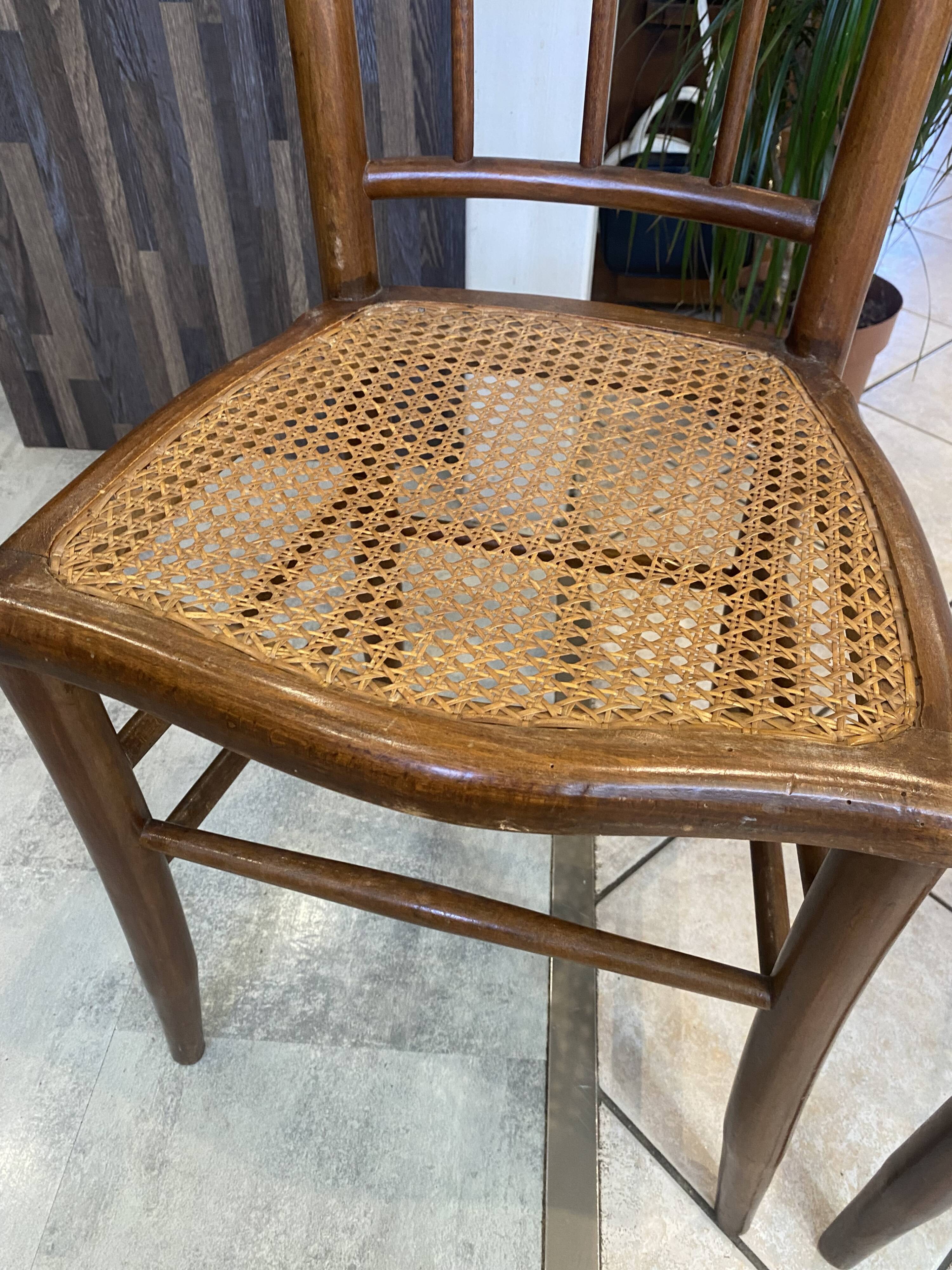 Pair of antique caned and wooden chairs from the 1900s.