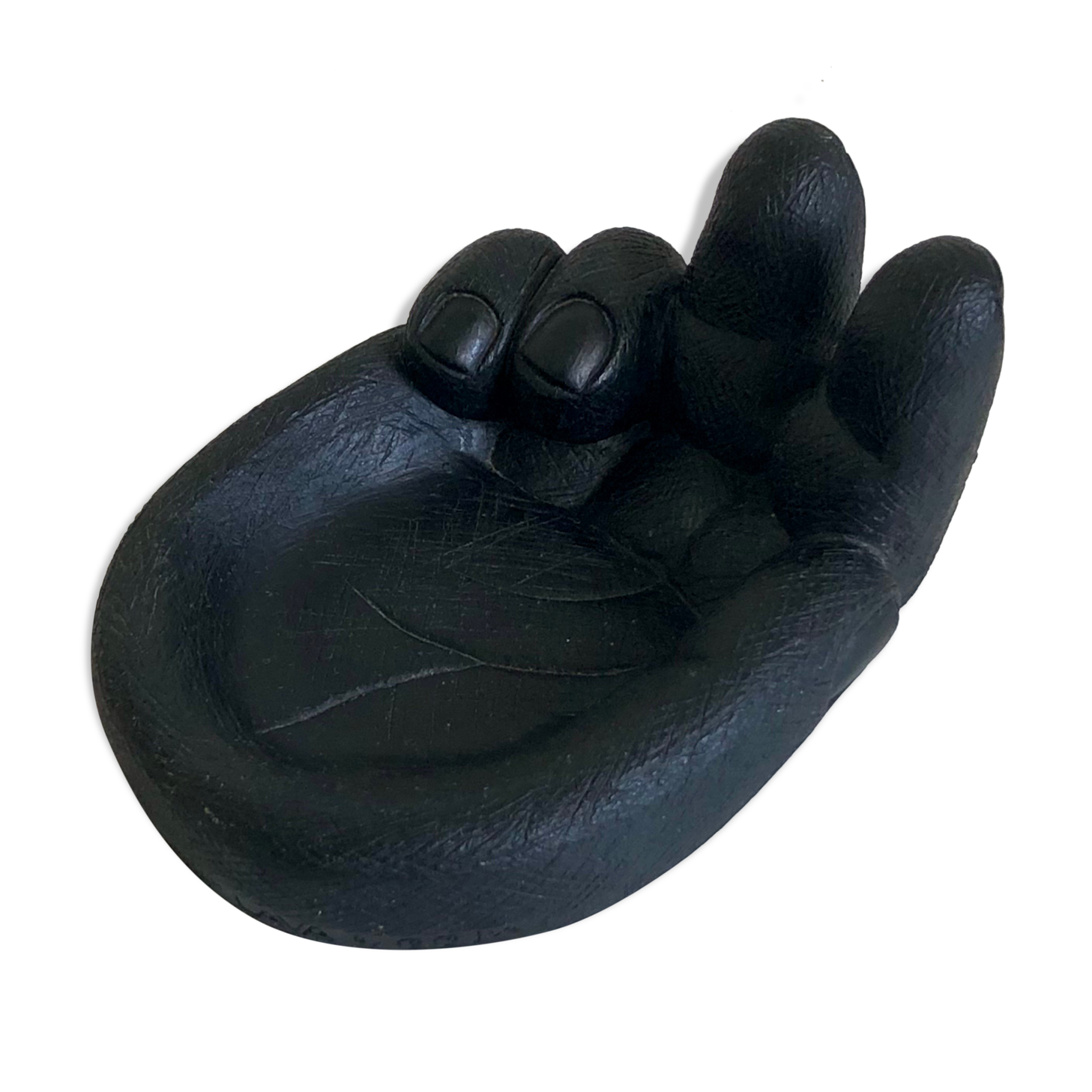 Empty pocket in Hawaiian lava in the shape of a hand signed Coco Joe, 1960