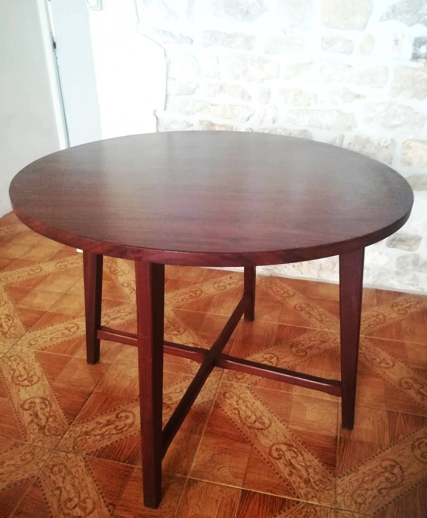 Round wooden table with thin legs