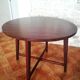 Round wooden table with thin legs