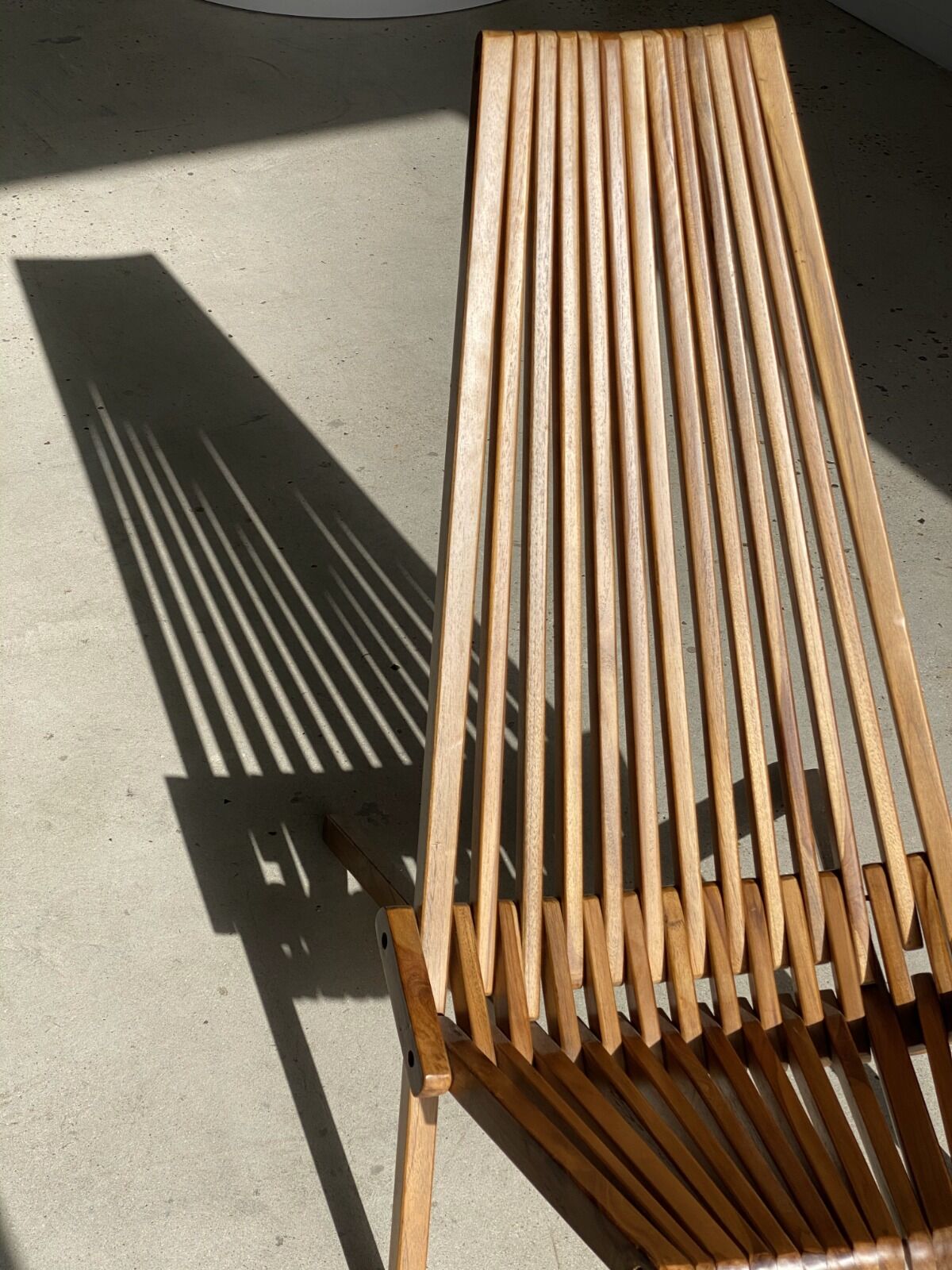 Foldable designer armchair in wooden slats