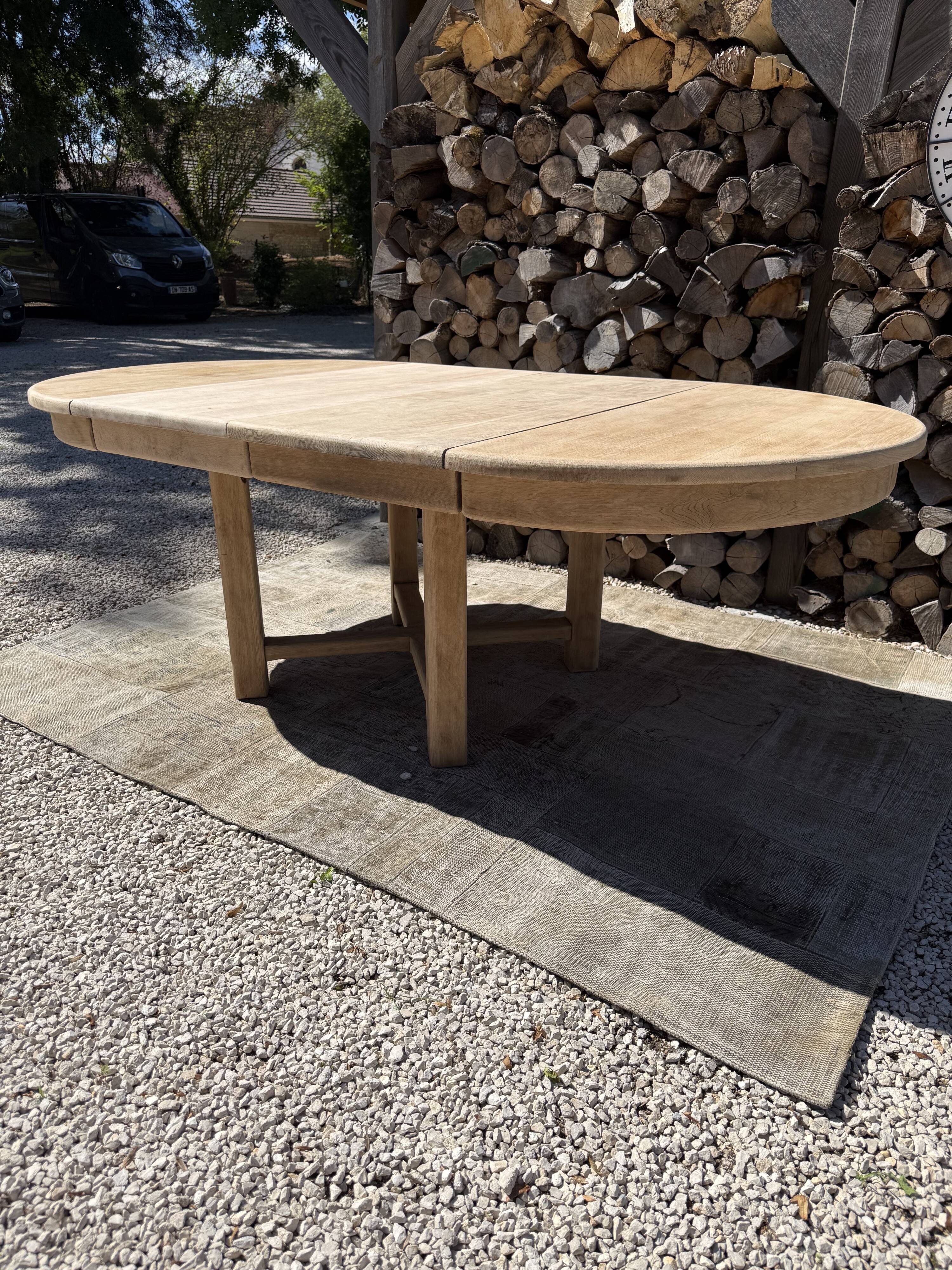 Round solid oak table with extensions, maximum 220cm.