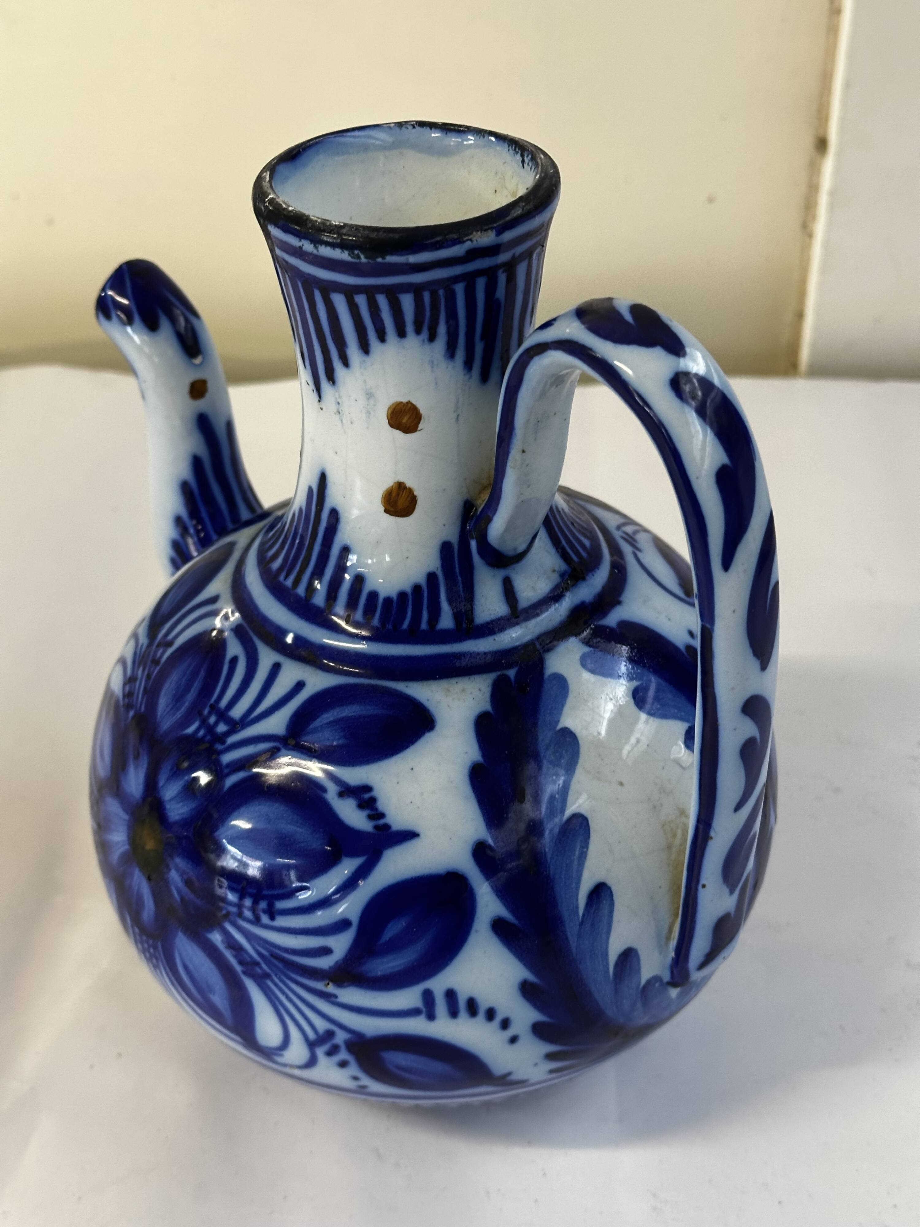 Glazed ceramic carafe with floral decoration