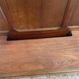 Antique wooden coat rack with mirror and shelf.