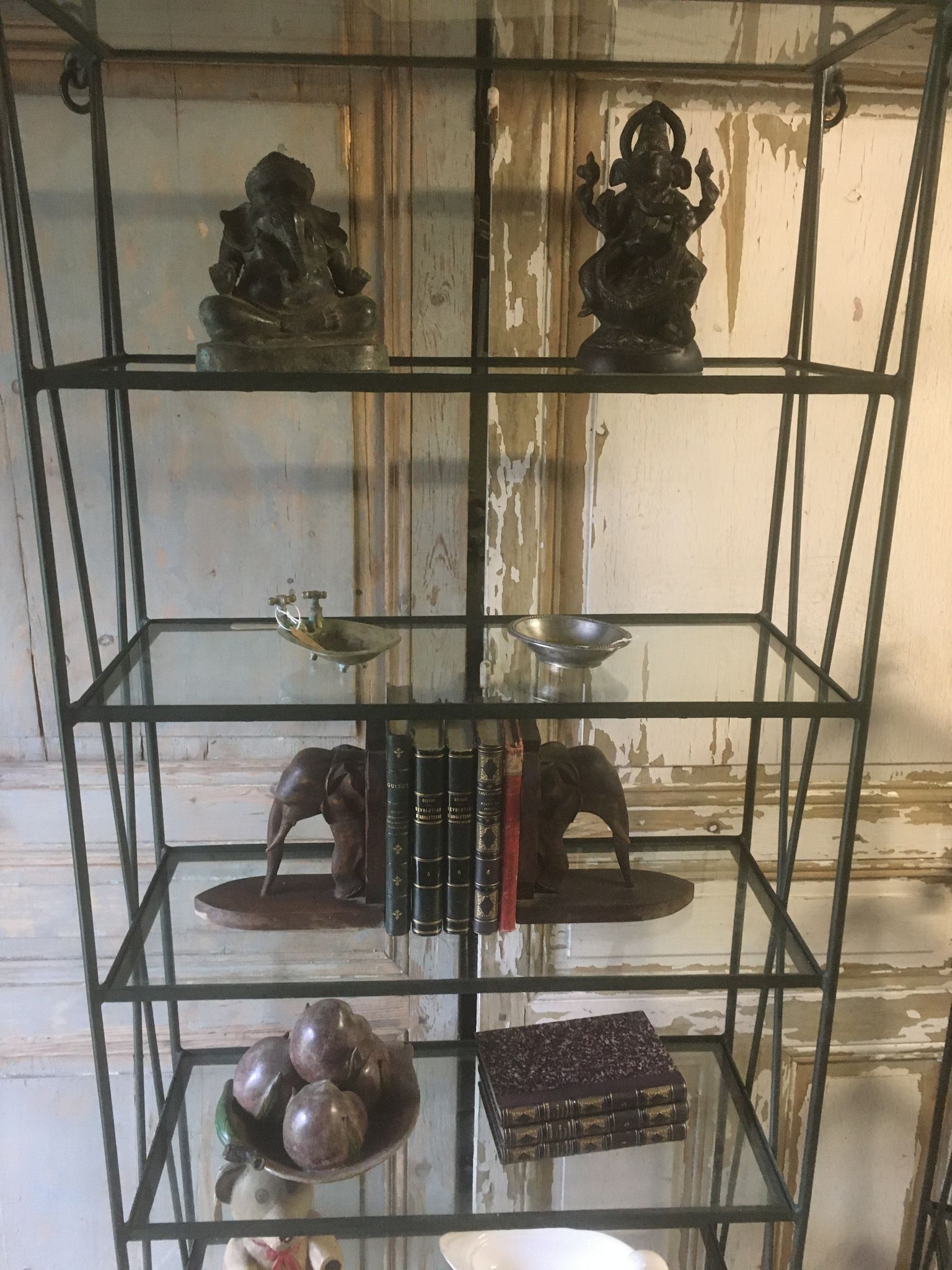 Pair of wrought iron and glass bookshelf shelves.