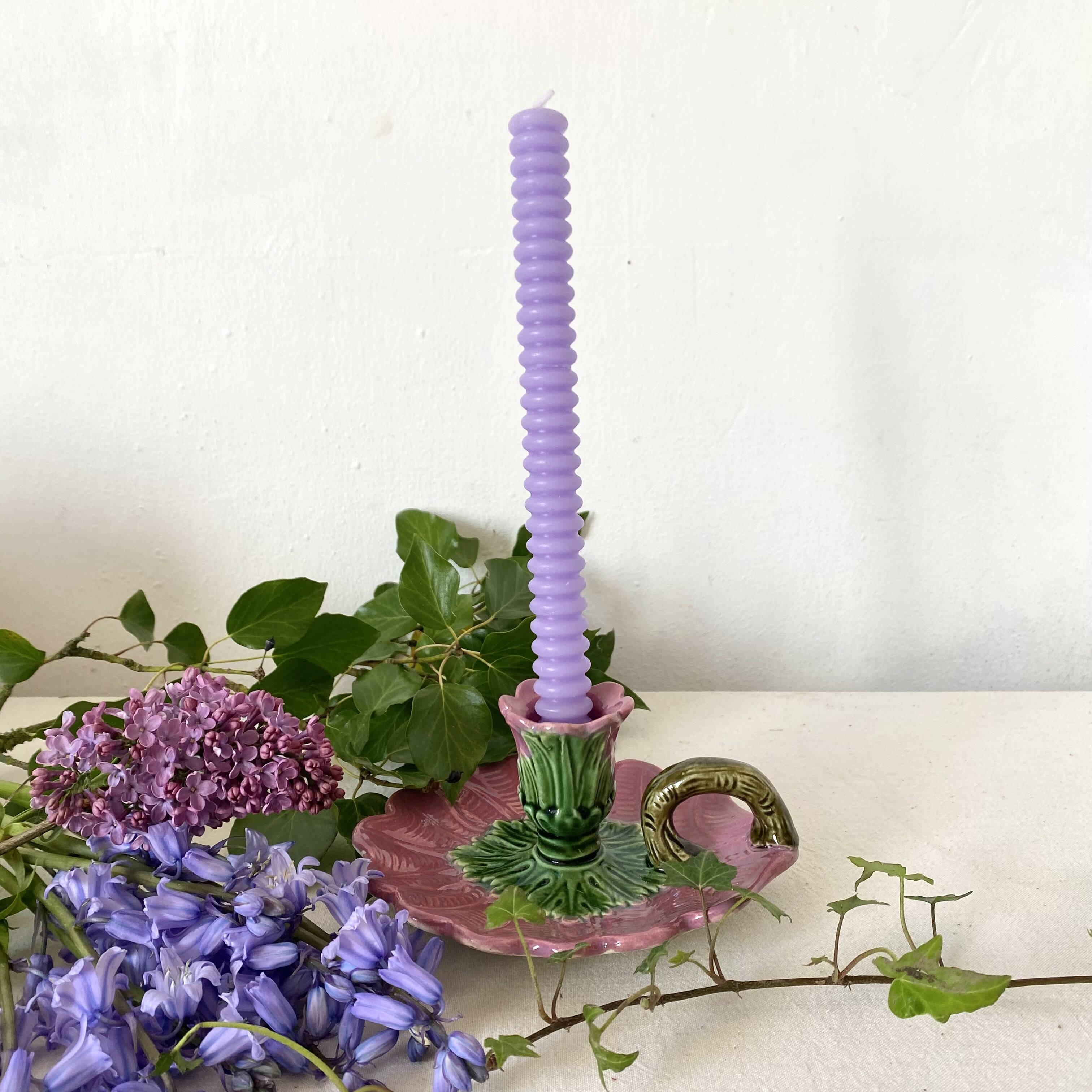 Antique slip candlestick depicting a flower