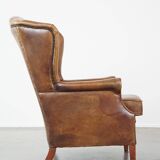 Charming sheep leather wingback armchair with a beautiful patina and excellent seating comfort