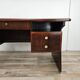 Art Deco executive desk in exotic wood, glass, and brass.
