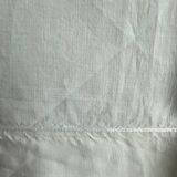 White hand-embroidered square tablecloth at stem stitch