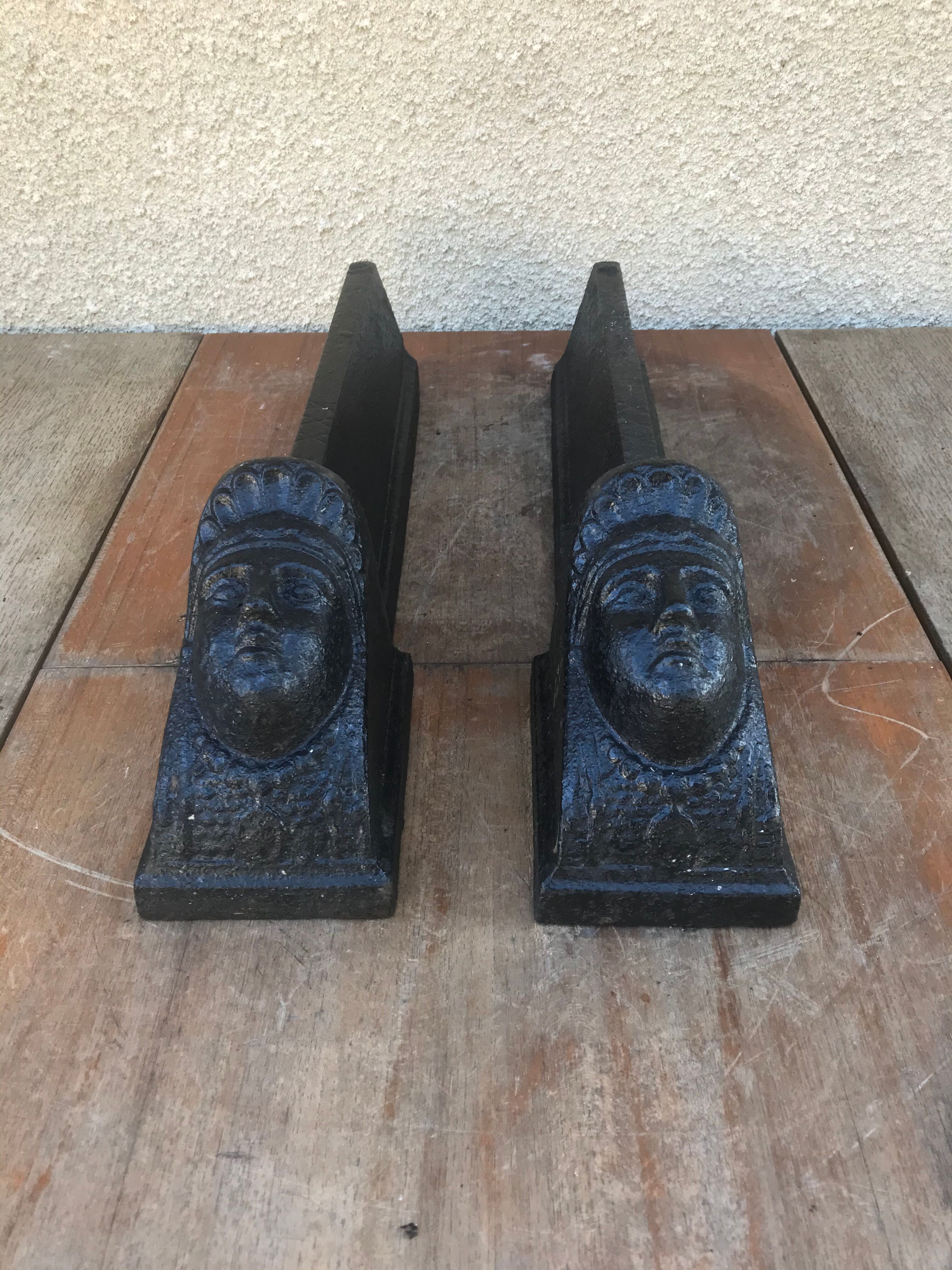 Old pair of chimney caterpillars shape of the head of a woman in iron