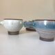 Lot 7 cups and saucers sandstone by Roger Jacques