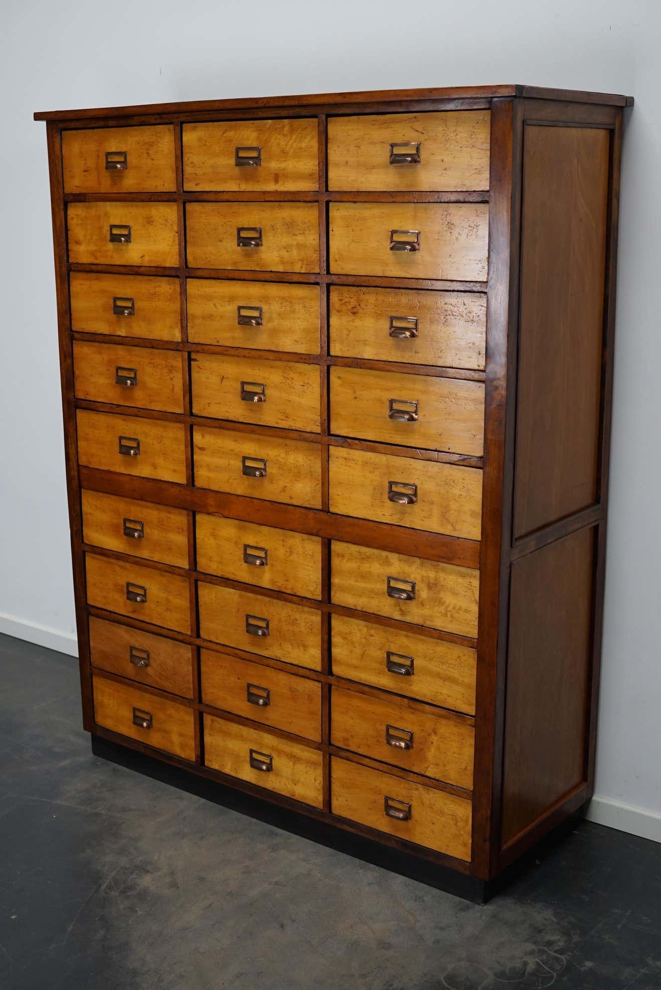School cabinet bank of vintage Dutch drawers in mid-twentieth century pine