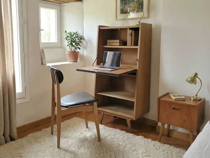 Vintage 1960s secretary desk with an angled design, light wood, and tapered legs.