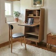 Vintage 1960s secretary desk with an angled design, light wood, and tapered legs.