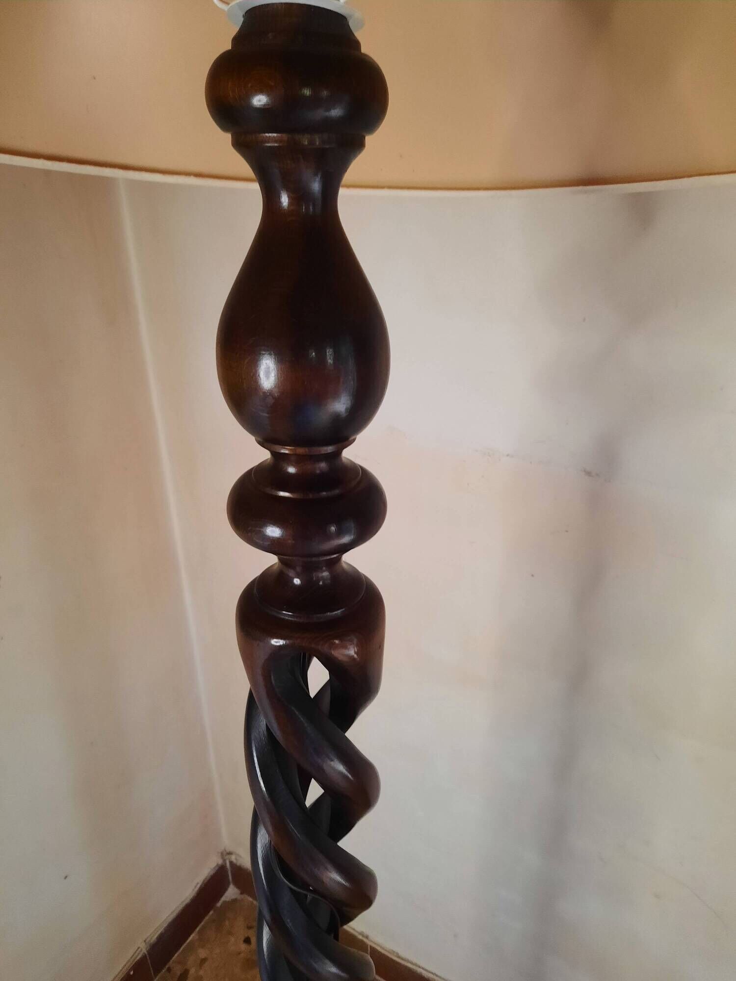 Sculptural floor lamp made of twisted turned wood.