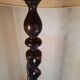 Sculptural floor lamp made of twisted turned wood.