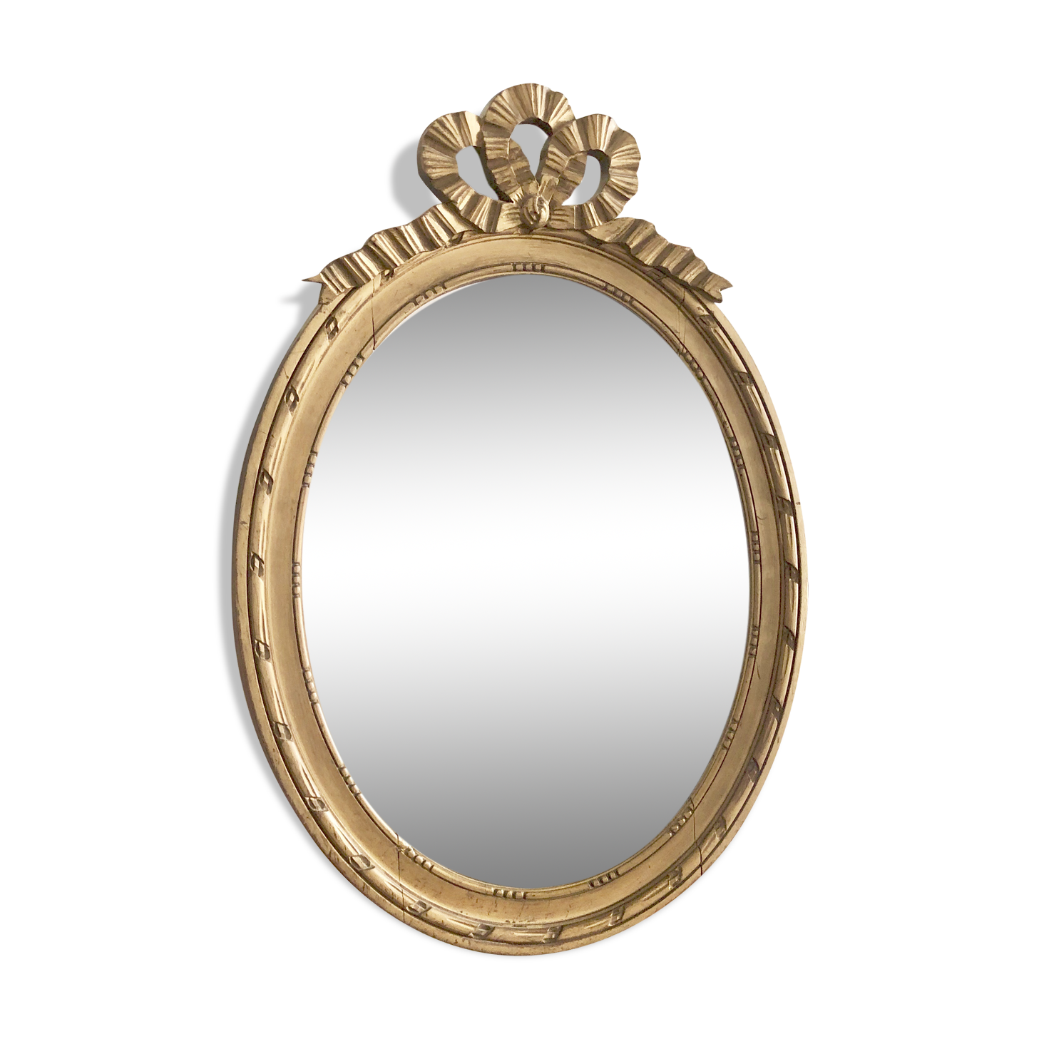 Old oval mirror with a pediment