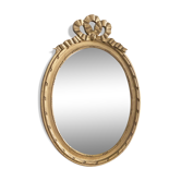 Old oval mirror with a pediment