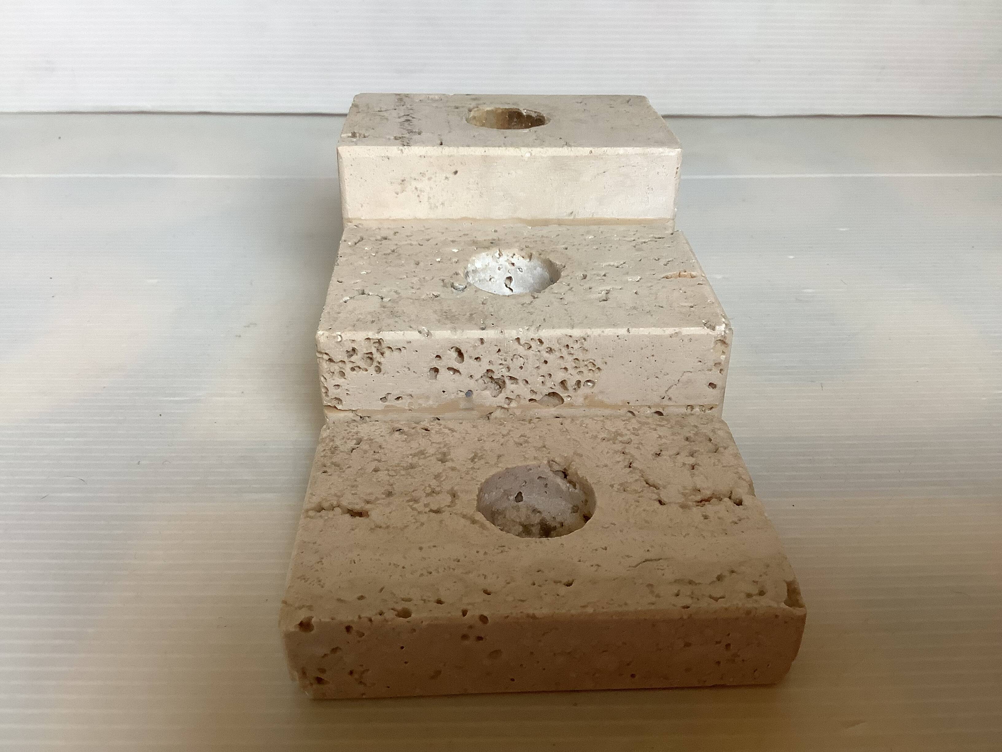 Trio of travertine candlesticks