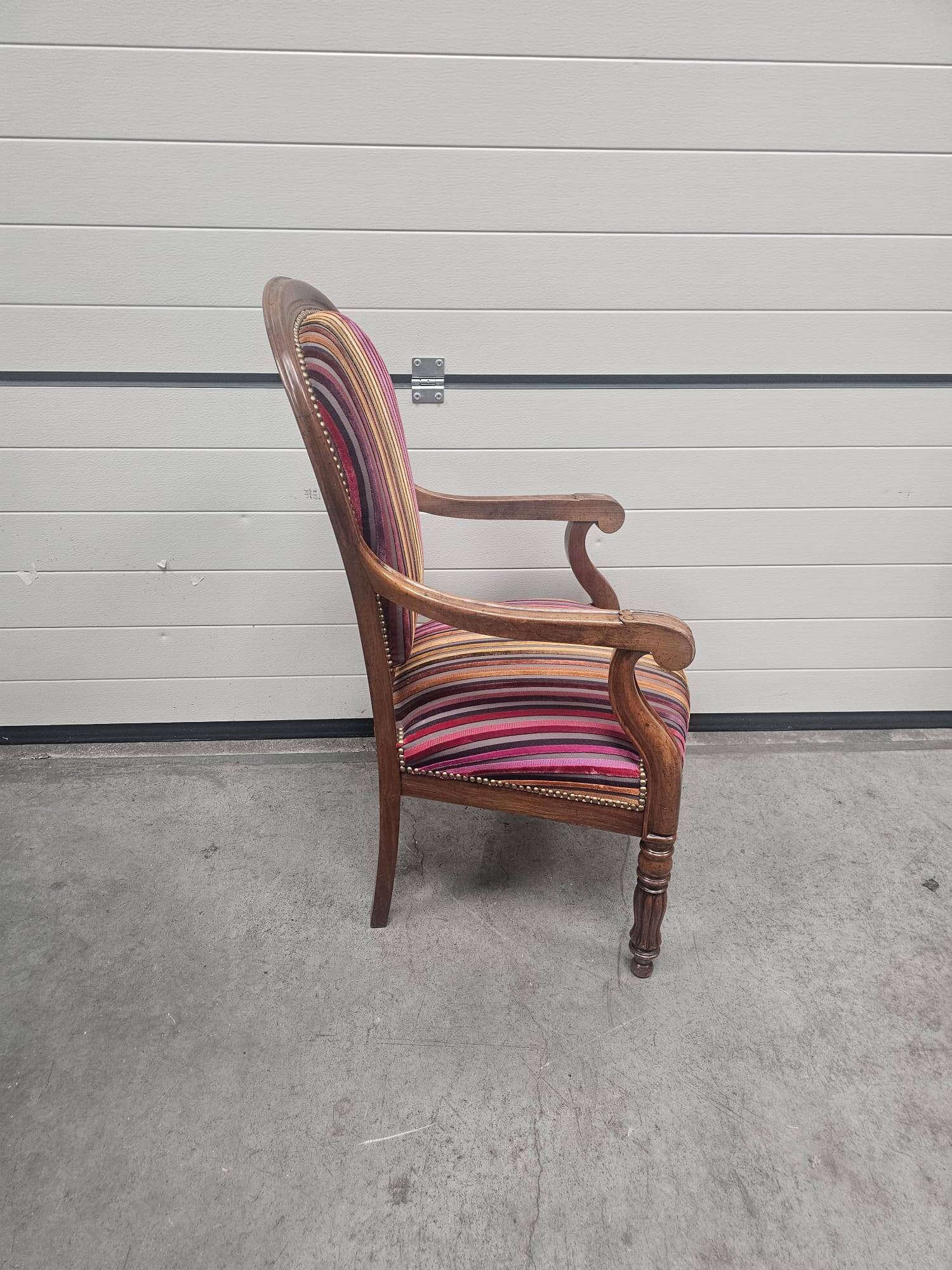 Antique armchair in multi-colored striped velvet with turned legs