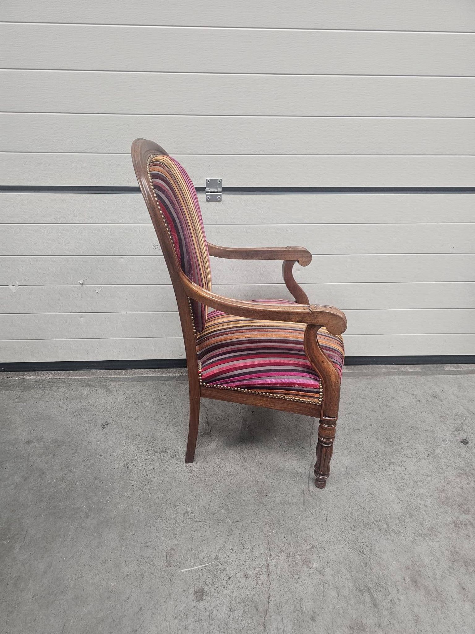 Antique striped multicoloured velvet armchair with turned legs.