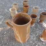 Service mazagrans and decanter in enamelled stoneware.