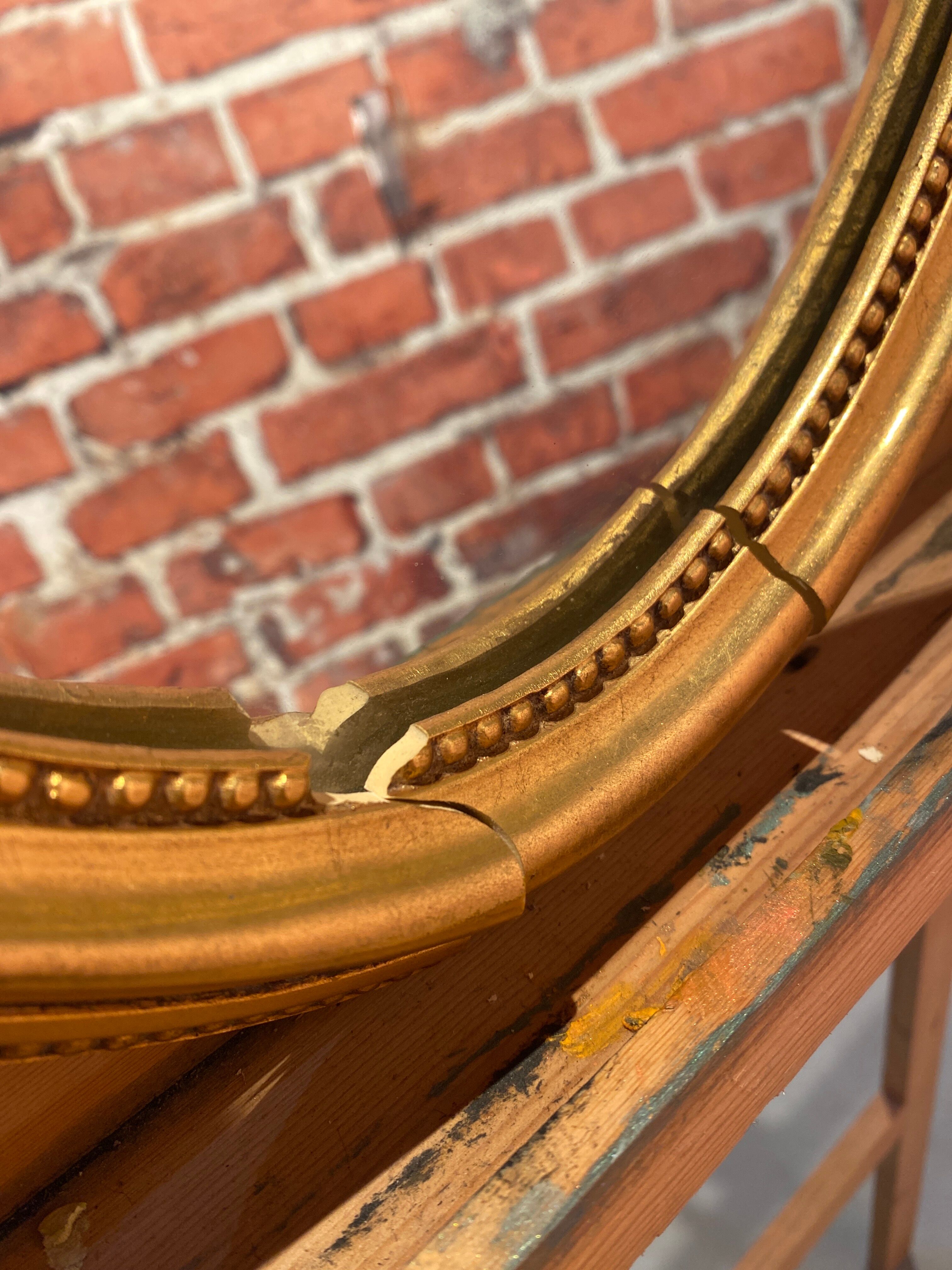 Oval mirror in a frame