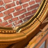 Oval mirror in a frame