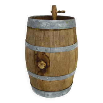 Old vinegar barrel in wood with metal strapping complete with tap. Folk art