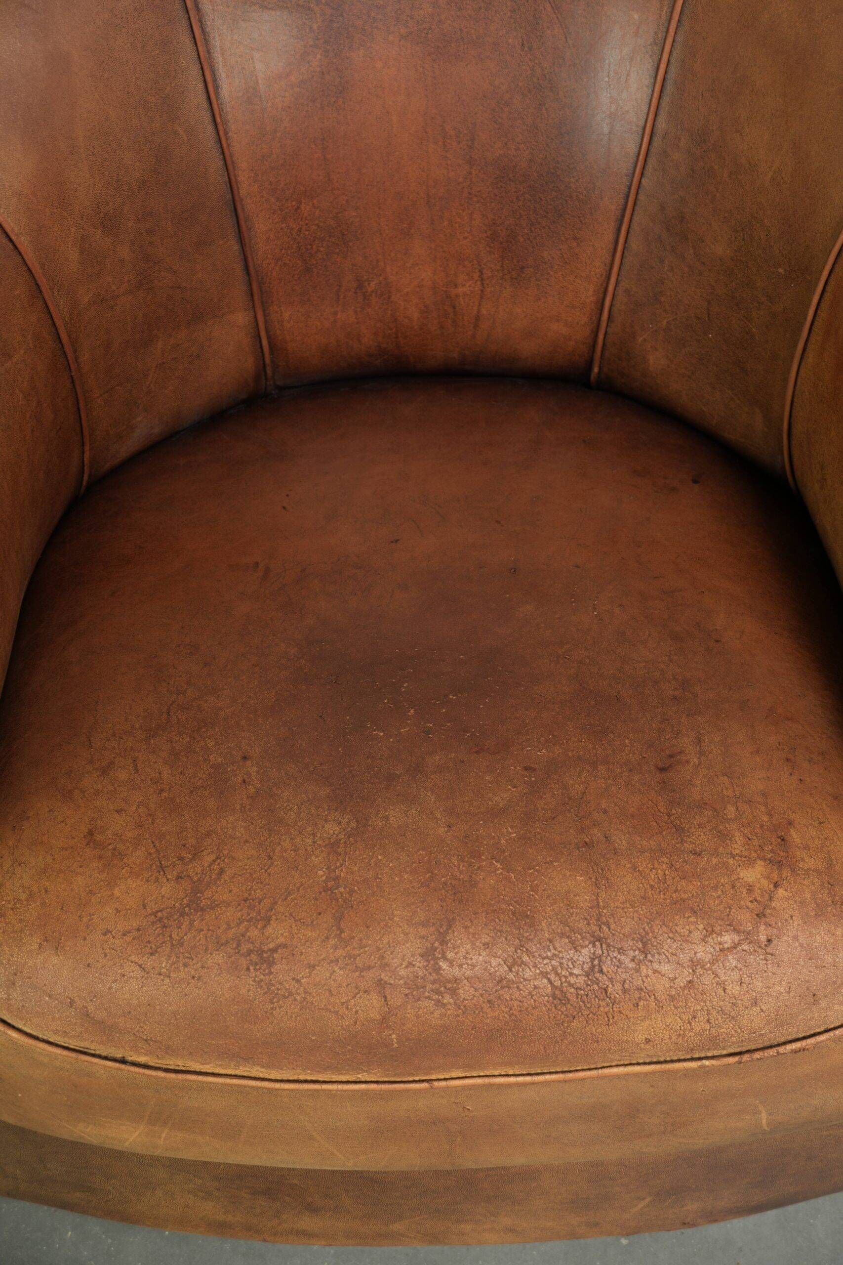 Aged sheepskin clubchair with beautiful vintage patina and comfortable seat