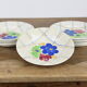 Lot de 12 assiettes motif fleurs de champagne.