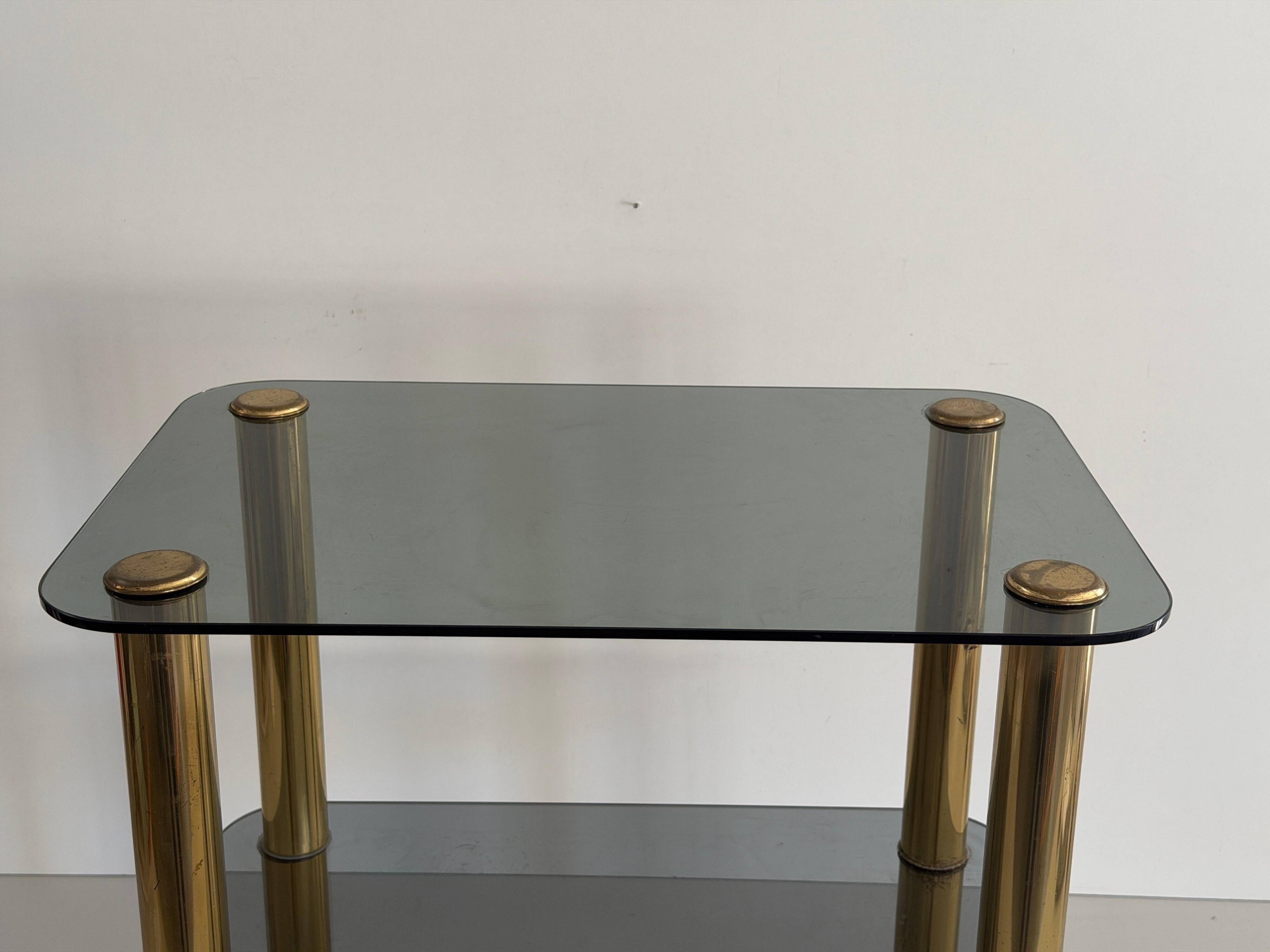 Side table in thick greenish glass with brass legs, Italy, 1960s.